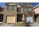 Brick townhouse exterior with a two-car garage and landscaping at 3551 Brycewood Dr, Decatur, GA 30034