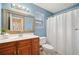 Bathroom features wood cabinets, white counters, and a large mirror at 1379 Paddocks Way, Powder Springs, GA 30127