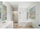 Bright bathroom featuring soaking tub with tile surround, walk-in shower, and double vanity at 1379 Paddocks Way, Powder Springs, GA 30127