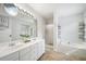 Spacious bathroom featuring double vanity, soaking tub, stand up shower, and linen storage at 1379 Paddocks Way, Powder Springs, GA 30127