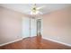 Cozy bedroom featuring hardwood floors, ceiling fan, and closet access at 1379 Paddocks Way, Powder Springs, GA 30127