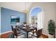 Bright dining room featuring hardwood floors, arched window, a painting and dining room set at 1379 Paddocks Way, Powder Springs, GA 30127