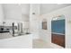 Bright kitchen with stainless steel appliances, white cabinetry, and a view into the living area through arched openings at 1379 Paddocks Way, Powder Springs, GA 30127