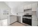 Clean, bright kitchen featuring stainless steel appliances, white cabinets, and a window above the sink at 1379 Paddocks Way, Powder Springs, GA 30127