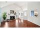 Bright living room featuring a fireplace, hardwood floors, and an open layout with arched doorways leading to other spaces at 1379 Paddocks Way, Powder Springs, GA 30127