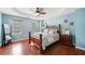 Cozy main bedroom featuring a tray ceiling, ceiling fan, ample natural light, and ensuite at 1379 Paddocks Way, Powder Springs, GA 30127