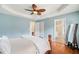 Well-lit main bedroom with hardwood floors, tray ceiling, and a view into the ensuite bathroom and closets at 1379 Paddocks Way, Powder Springs, GA 30127