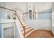 Elegant staircase with wooden steps, white risers and railings, leading to a bright and airy second floor at 1379 Paddocks Way, Powder Springs, GA 30127