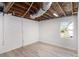 Unfinished basement space featuring exposed ceiling, ductwork, and painted white brick at 1490 Broad Ne St, Conyers, GA 30012