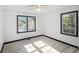 Empty bedroom featuring white walls, black trim, and wood-look floors at 1490 Broad Ne St, Conyers, GA 30012