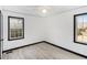 Neutral bedroom highlighting two windows and wood-look floors at 1490 Broad Ne St, Conyers, GA 30012