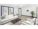 Cozy living room with white sofa set, coffee table, rug, and a large window at 1490 Broad Ne St, Conyers, GA 30012