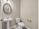 Clean bathroom with pedestal sink, toilet and stylish mirror at 1538 Park Grove Dr, Lawrenceville, GA 30046