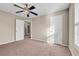 This bedroom has carpet, light colored walls and a ceiling fan at 1538 Park Grove Dr, Lawrenceville, GA 30046