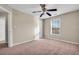 This bedroom has carpet, light colored walls and a ceiling fan at 1538 Park Grove Dr, Lawrenceville, GA 30046