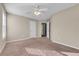 Bedroom with carpet, ceiling fan, and access to hallway at 1538 Park Grove Dr, Lawrenceville, GA 30046