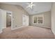 The carpeted bedroom includes an ensuite bathroom and a window that looks out onto the trees at 1538 Park Grove Dr, Lawrenceville, GA 30046