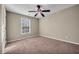 This bedroom has carpet, light colored walls and a ceiling fan at 1538 Park Grove Dr, Lawrenceville, GA 30046