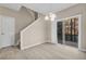 Dining area features sliding glass doors to deck, stairs to upper level, and modern light fixture at 1538 Park Grove Dr, Lawrenceville, GA 30046