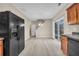 Open-concept kitchen with adjacent dining area, black refrigerator, and sliding glass doors to deck at 1538 Park Grove Dr, Lawrenceville, GA 30046