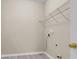 Simple laundry room featuring neutral walls, vinyl flooring, and metal storage shelf at 1538 Park Grove Dr, Lawrenceville, GA 30046