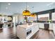 Modern kitchen with white island, open to living area, and dark tile backsplash at 2220 Meadowvale Ne Dr, Atlanta, GA 30345