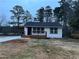 Newly renovated white house with a modern deck and driveway at 1840 Judy Se Cir, Marietta, GA 30060