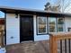 Black front door with modern window and wooden deck at 1840 Judy Se Cir, Marietta, GA 30060