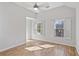Bright bedroom featuring hardwood floors and windows with shutter style blinds at 4974 Dovecote Trl, Suwanee, GA 30024