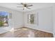 Bright bedroom featuring hardwood floors and plantation shutters at 4974 Dovecote Trl, Suwanee, GA 30024