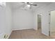 Empty bedroom featuring carpet, ceiling fan, and nearby walk-in closet at 4974 Dovecote Trl, Suwanee, GA 30024