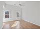 Bright bedroom featuring hardwood floors and windows with shutter style blinds at 4974 Dovecote Trl, Suwanee, GA 30024