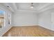 Spacious bedroom with hardwood floors, bright lighting, and ample sunlight at 4974 Dovecote Trl, Suwanee, GA 30024