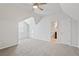 Spacious bonus room with vaulted ceiling and light gray carpet at 4974 Dovecote Trl, Suwanee, GA 30024