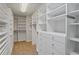 Walk-in closet with built-in shelving and hanging space at 4974 Dovecote Trl, Suwanee, GA 30024