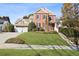 Brick and shingle two-story house with a two-car garage and landscaped lawn at 4974 Dovecote Trl, Suwanee, GA 30024