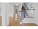 Bright foyer featuring hardwood floors, staircase, and white trim at 4974 Dovecote Trl, Suwanee, GA 30024