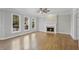 Gathering room with hardwood floors, fireplace and ceiling fan at 4974 Dovecote Trl, Suwanee, GA 30024