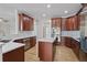 Modern kitchen featuring wood cabinets, stainless steel appliances, and a marble countertop at 4974 Dovecote Trl, Suwanee, GA 30024