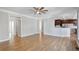 Open-concept living area with hardwood floors, and kitchen access at 4974 Dovecote Trl, Suwanee, GA 30024