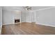 Spacious living room featuring fireplace, hardwood floors, and modern ceiling fan at 4974 Dovecote Trl, Suwanee, GA 30024