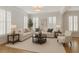 Bright living room featuring hardwood floors, neutral paint, and shuttered windows at 4974 Dovecote Trl, Suwanee, GA 30024
