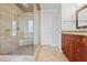 Large walk-in shower with tile surround and built-in seat at 4974 Dovecote Trl, Suwanee, GA 30024