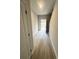 Neutral-toned hallway with wood-look flooring and access to exterior at 100 Deer Xing, Temple, GA 30179