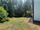 Spacious backyard with grassy area and deck, backing up to wooded area at 114 Jousters Ln, Lawrenceville, GA 30044