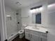 Modern bathroom with a white vanity, marble shower, and updated fixtures at 114 Jousters Ln, Lawrenceville, GA 30044