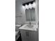 White quartz vanity with modern sink and lighting at 114 Jousters Ln, Lawrenceville, GA 30044
