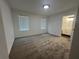 Spacious bedroom with plush carpeting and an ensuite bathroom at 114 Jousters Ln, Lawrenceville, GA 30044