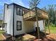 Elevated wooden deck with railings, attached to a two-story house at 114 Jousters Ln, Lawrenceville, GA 30044