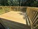 Wooden deck overlooking a wooded backyard at 114 Jousters Ln, Lawrenceville, GA 30044